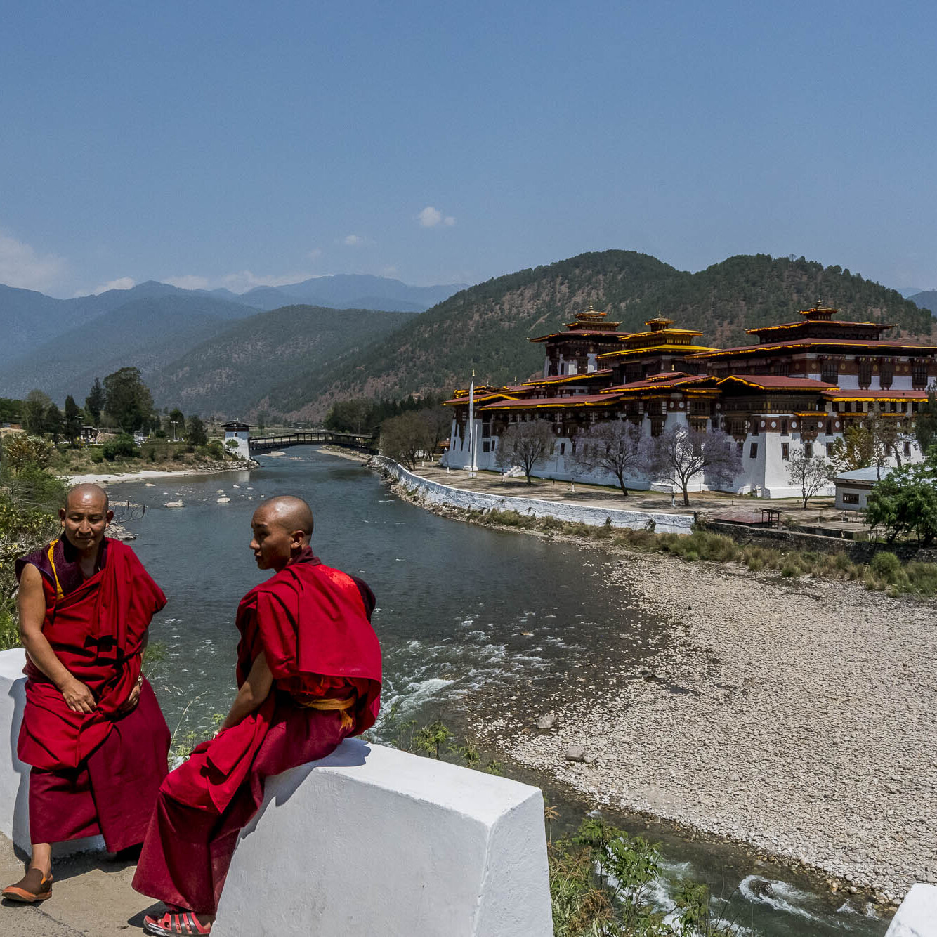 Two Bhutanese monks in front of a temple