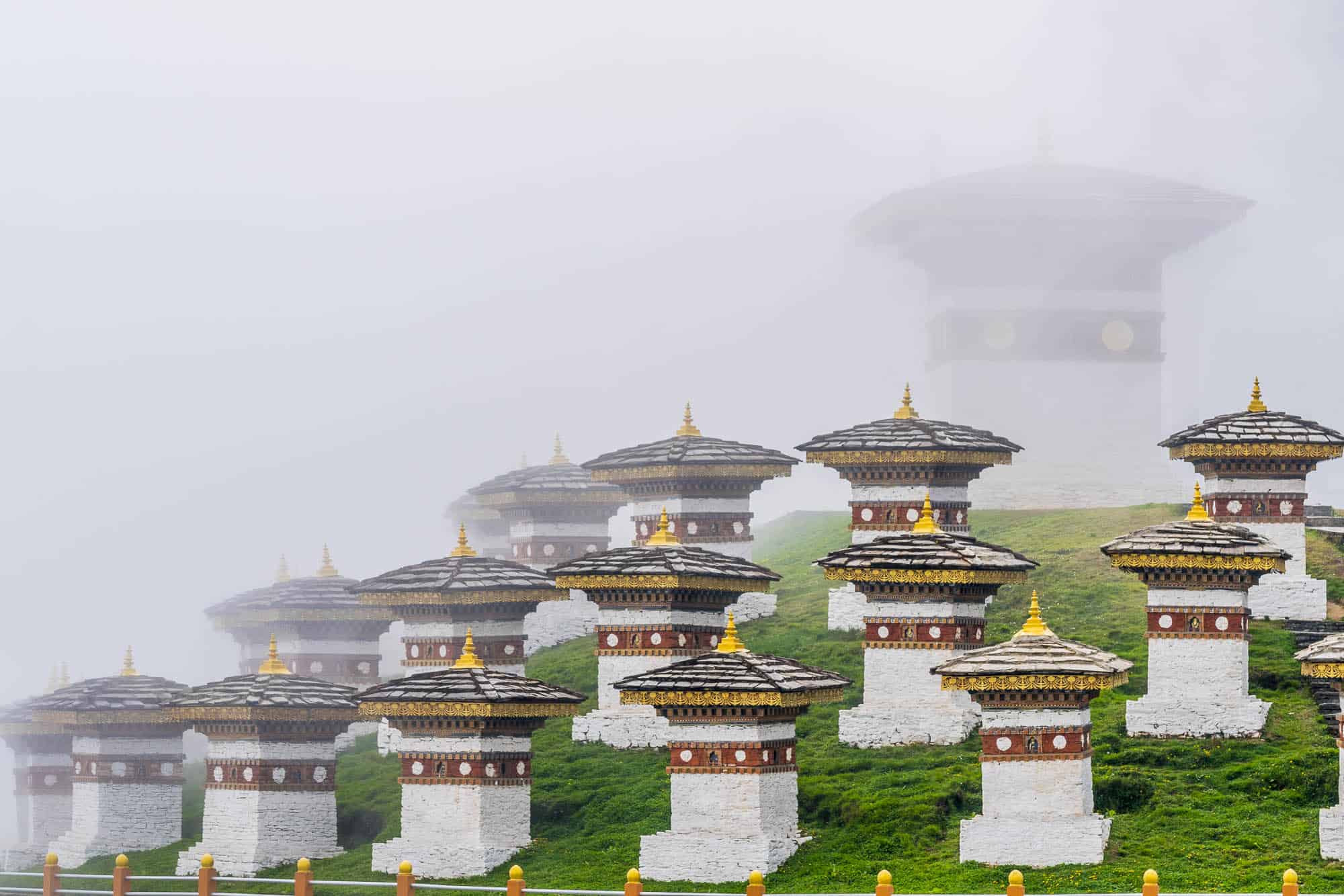 many structures aligned in front of a Bhutanese temple